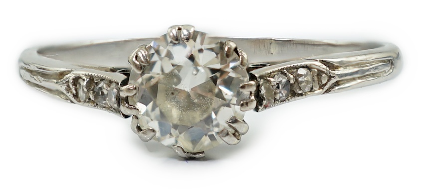 A platinum? and single stone diamond set ring, with six stone diamond chip set shoulders